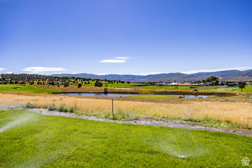 Property view of mountains featuring a water view