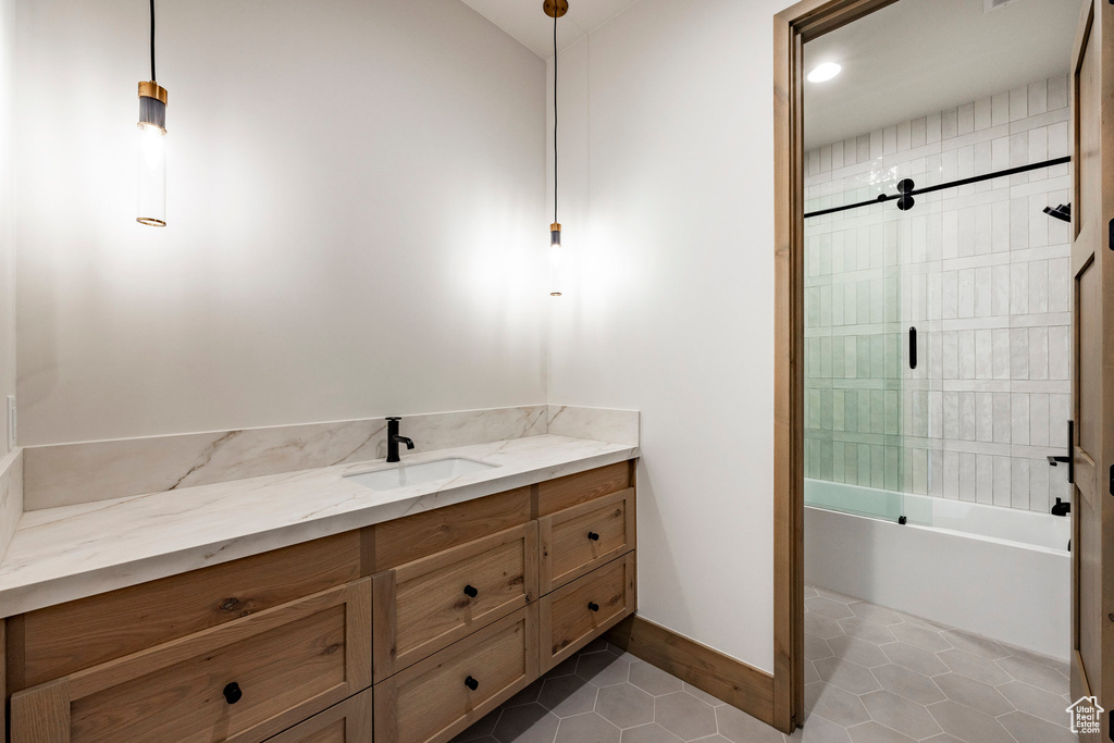 Bathroom with tile patterned flooring,  shower combination, and vanity