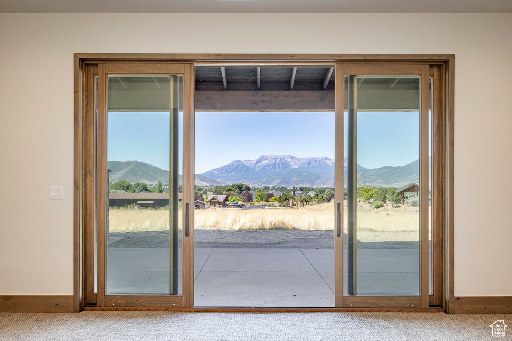 Doorway featuring a mountain view and carpet floors