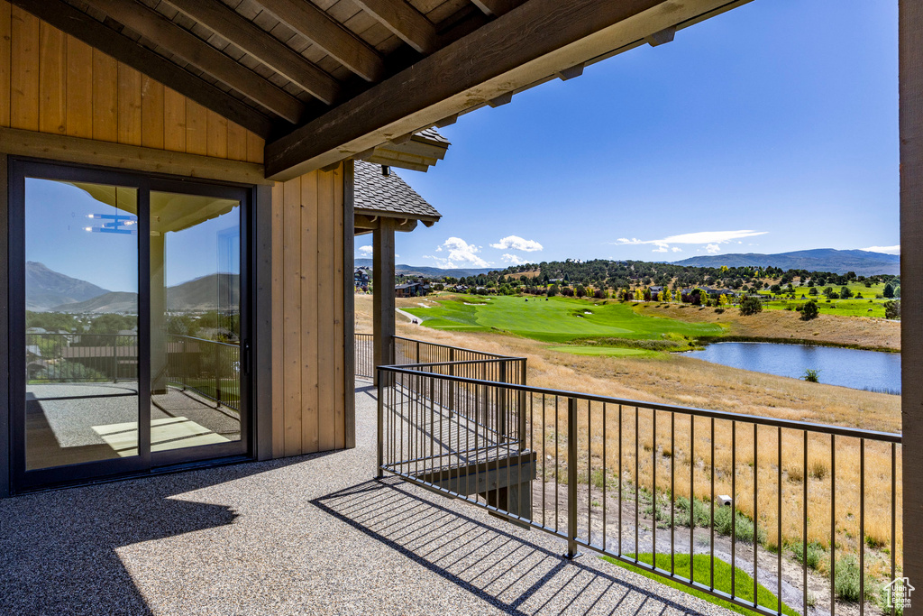 Balcony featuring a water and mountain view