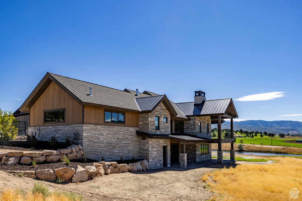 View of side of property with a mountain view