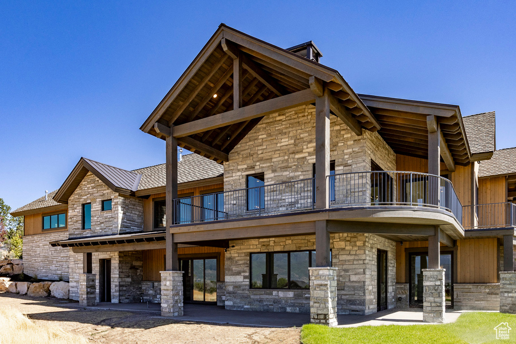 Rear view of house featuring a patio area and a balcony