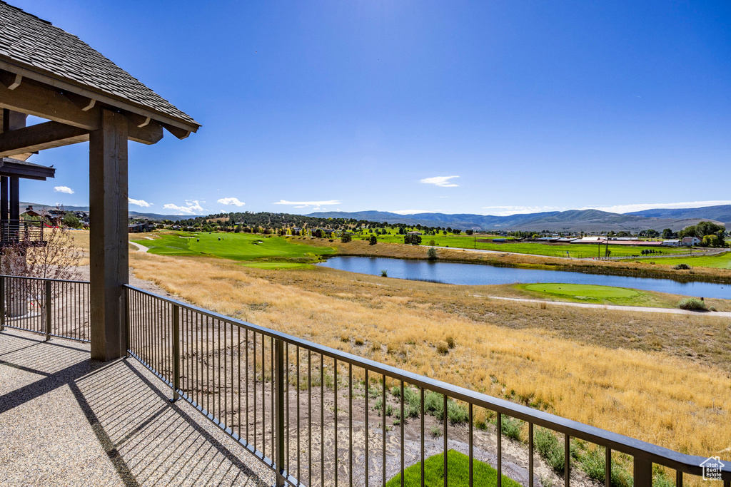 Balcony with a water and mountain view