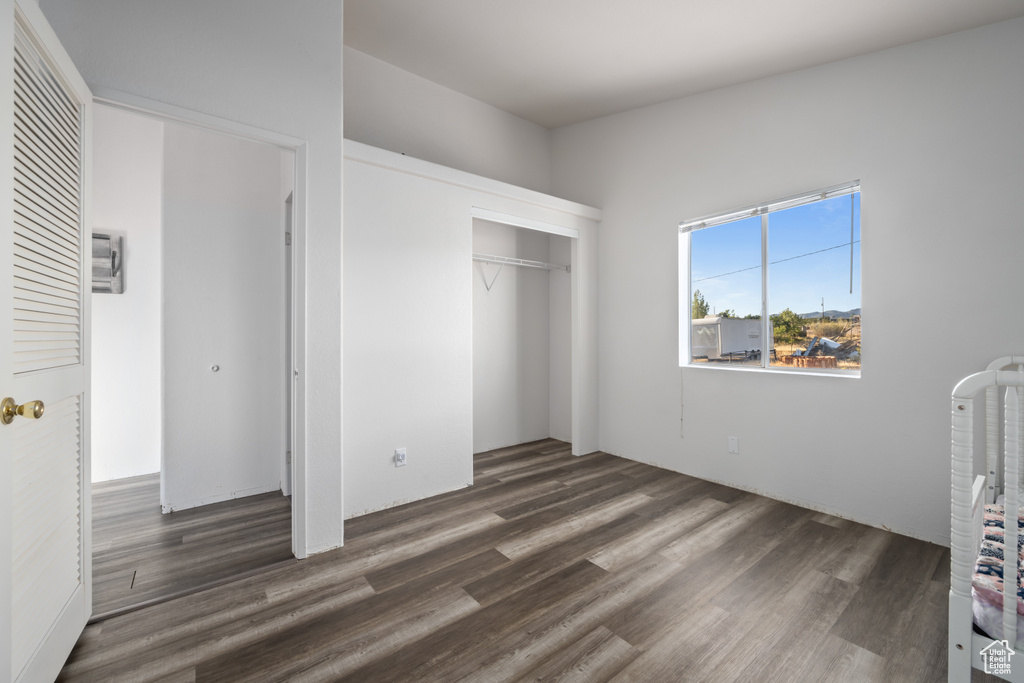 Unfurnished bedroom featuring hardwood / wood-style floors