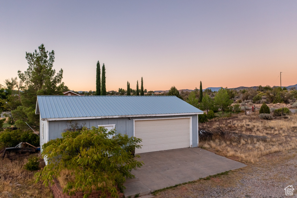 View of garage at dusk