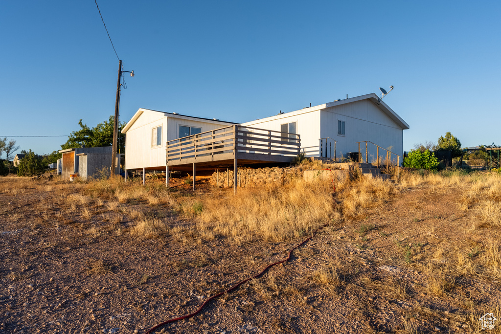 Back of property with a wooden deck