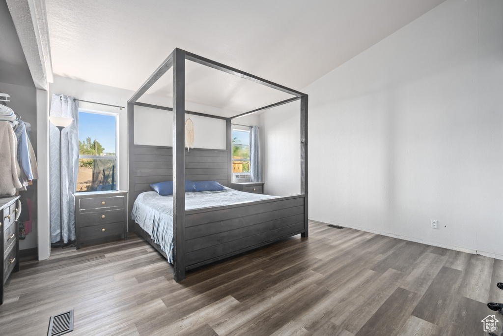 Bedroom featuring vaulted ceiling and wood-type flooring