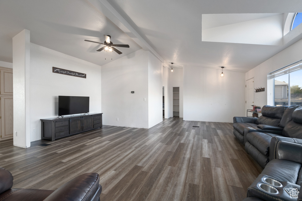 Unfurnished living room with beam ceiling, ceiling fan, high vaulted ceiling, and wood-type flooring