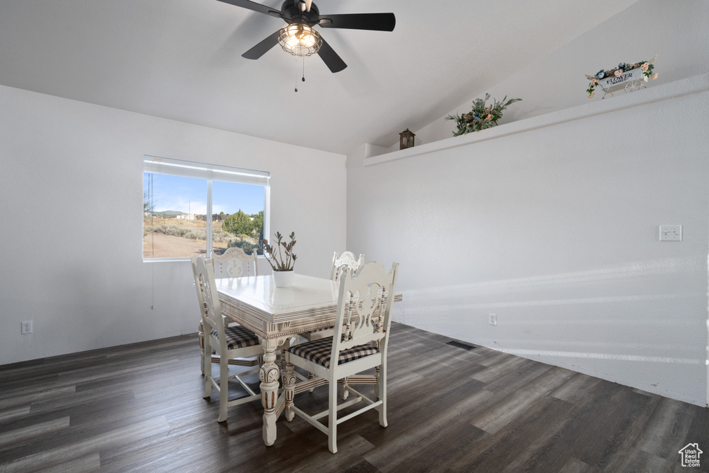 Dining room featuring ceiling fan, lofted ceiling, and wood-type flooring