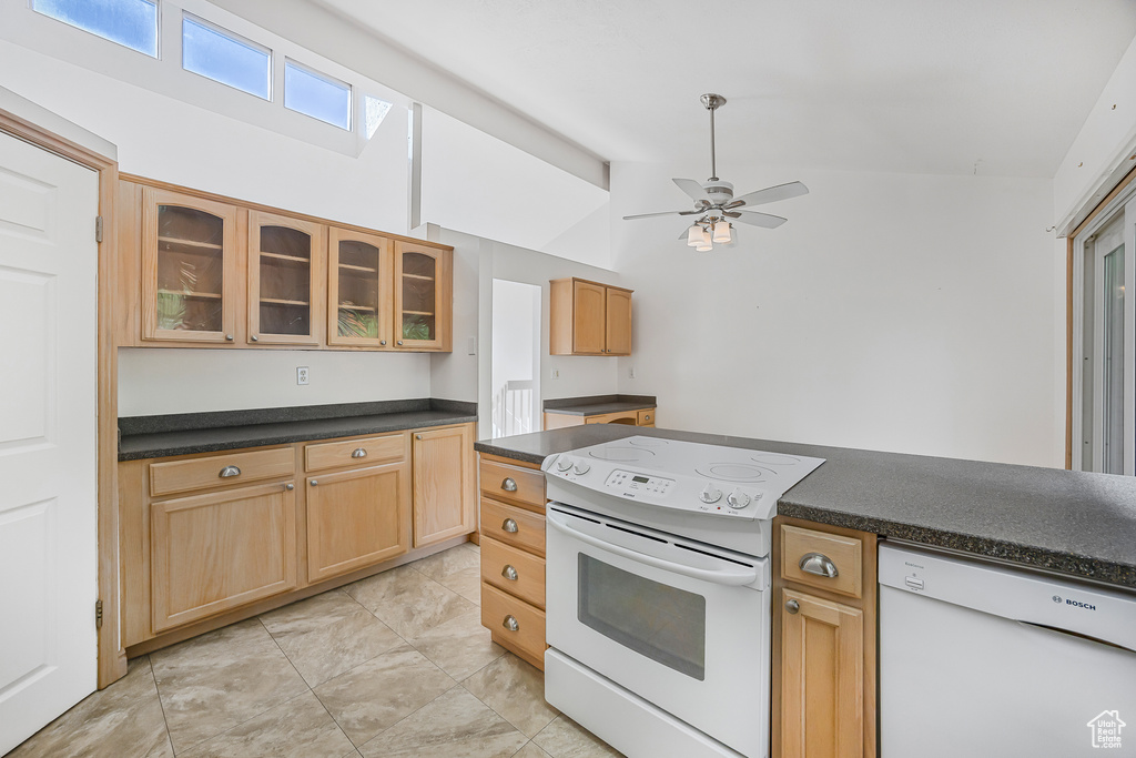 Kitchen featuring light tile patterned floors, high vaulted ceiling, ceiling fan, and white appliances