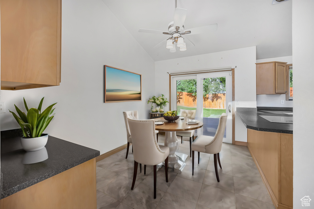 Tiled dining space with high vaulted ceiling and ceiling fan