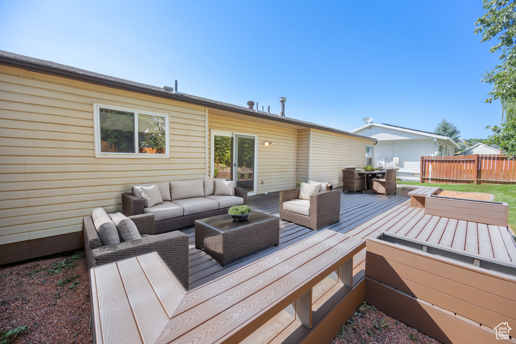 Wooden terrace featuring an outdoor living space