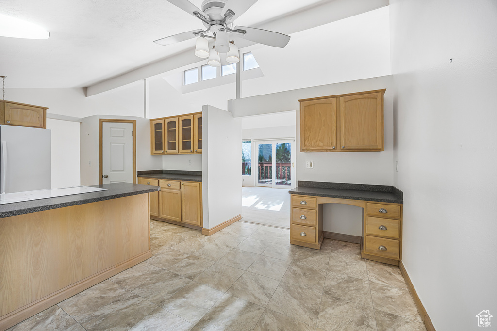 Kitchen featuring ceiling fan, a wealth of natural light, light tile patterned flooring, and white fridge