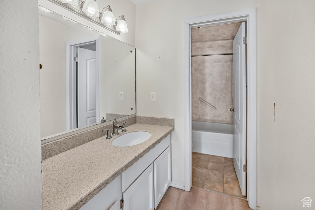 Bathroom featuring tile patterned floors, shower / washtub combination, and vanity