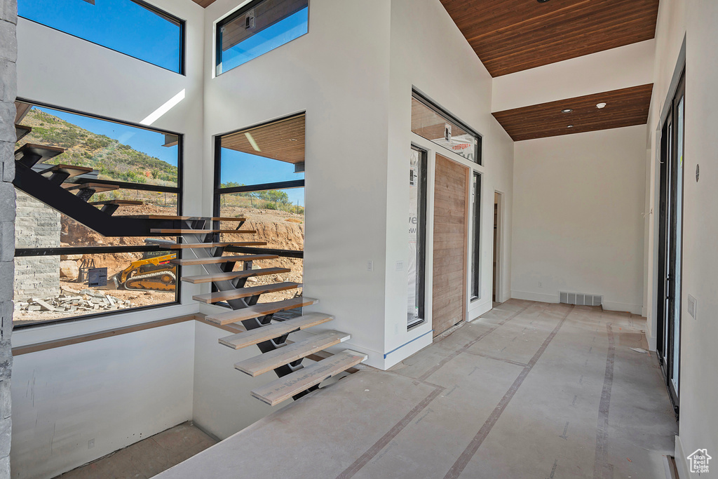 Corridor featuring wooden ceiling and a towering ceiling