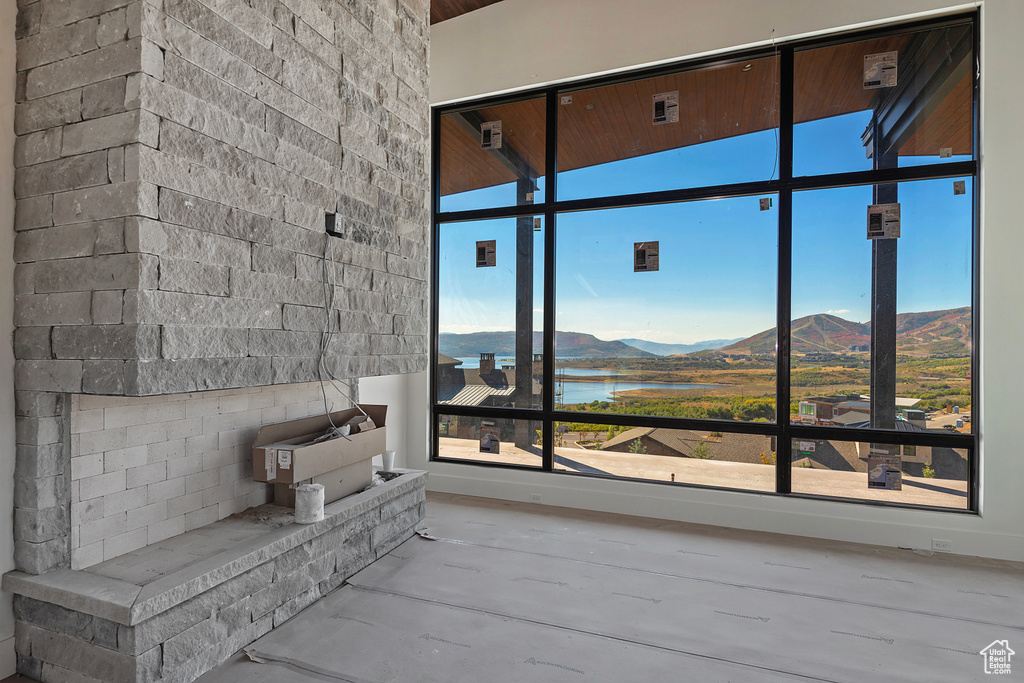 Interior space with concrete floors and a water and mountain view