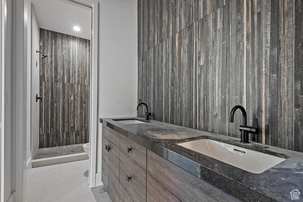 Bathroom with a shower, vanity, toilet, and tile patterned floors