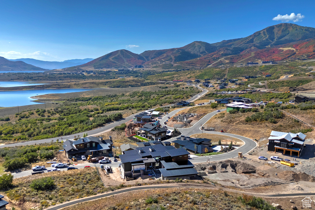 Drone / aerial view featuring a water and mountain view