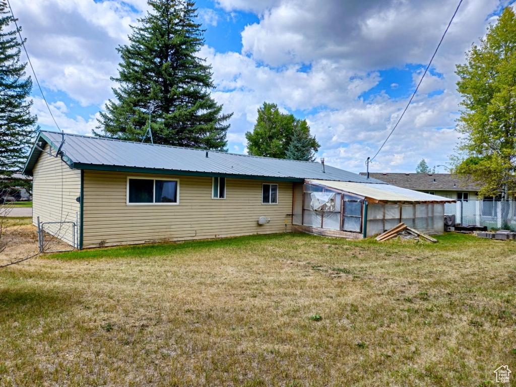 Back of property featuring a yard