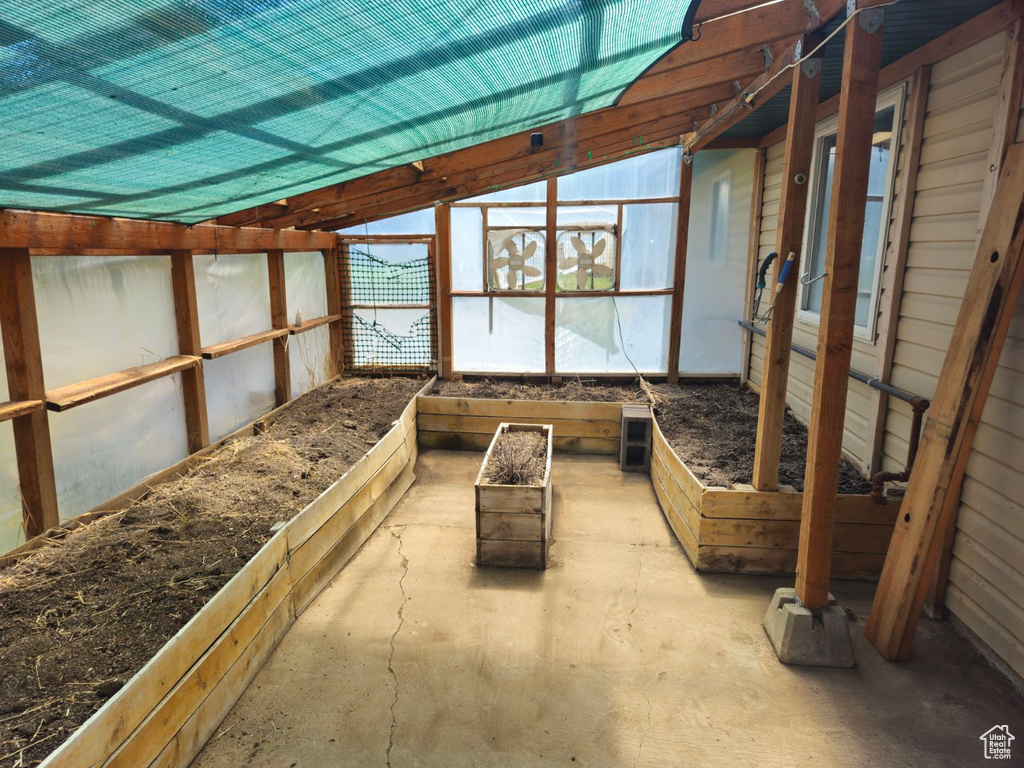 Unfurnished sunroom with vaulted ceiling