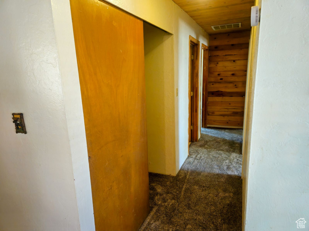 Corridor with wood ceiling and carpet floors