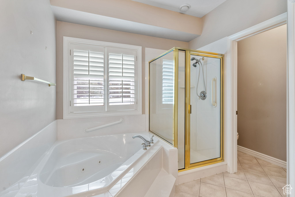 Bathroom with plus walk in shower and tile patterned floors