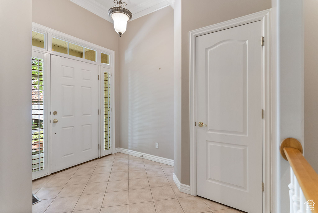 Tiled foyer with ornamental molding