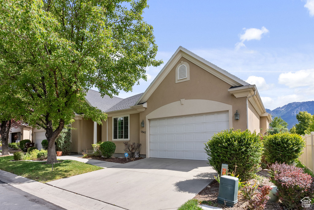 View of front of house featuring a garage and a mountain view