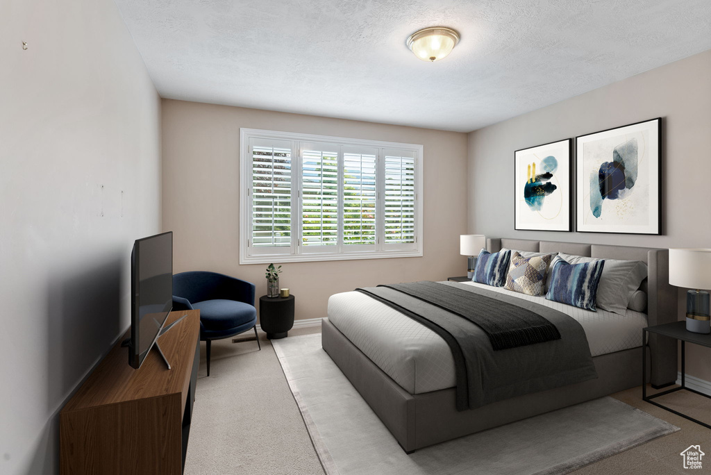 Carpeted bedroom featuring a textured ceiling