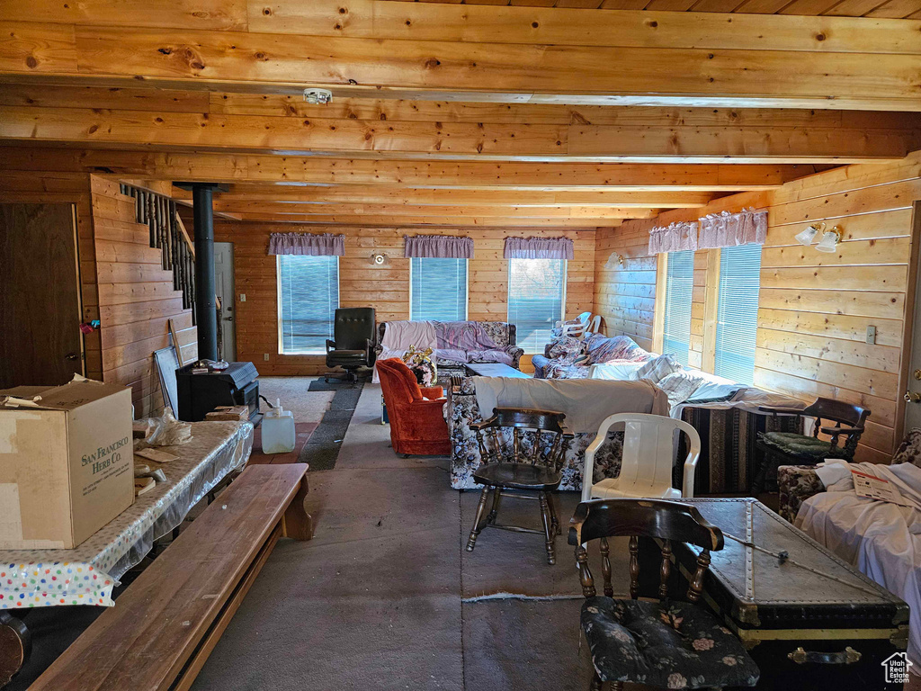 Living room with wood walls, finished concrete flooring, and a healthy amount of sunlight