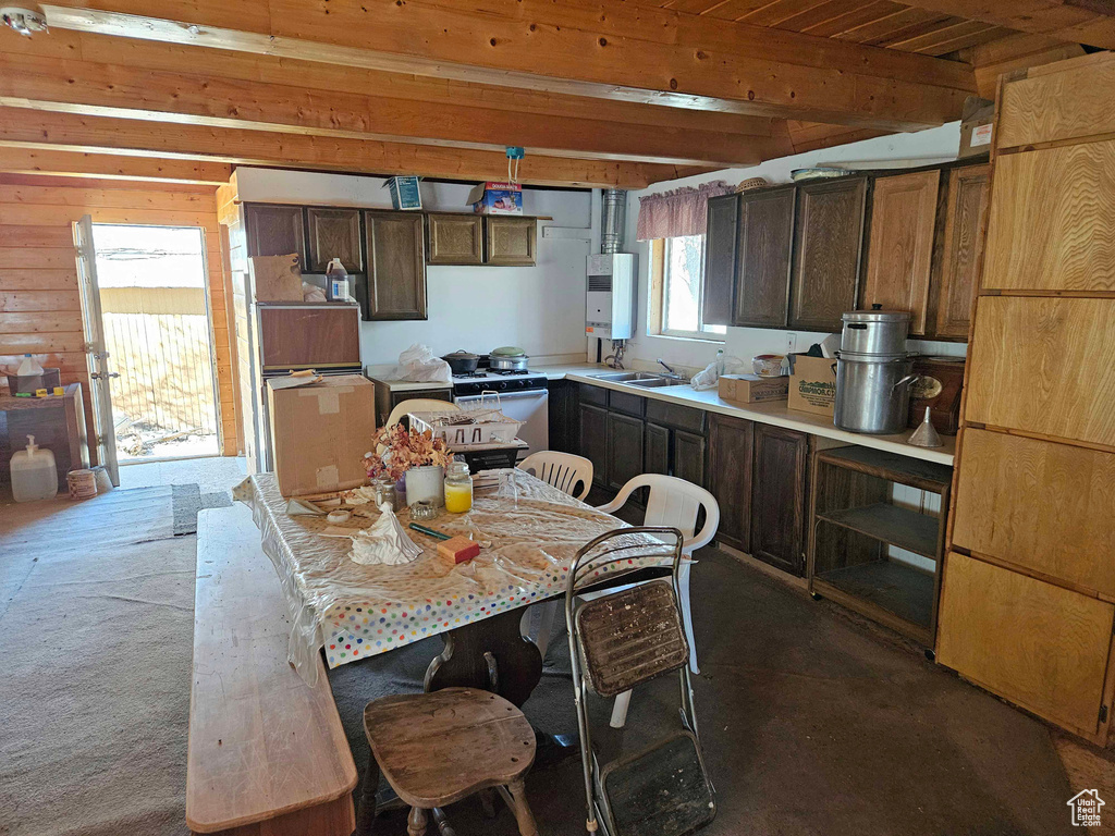 Kitchen with water heater, wooden ceiling, dark brown cabinetry, beamed ceiling, and light countertops
