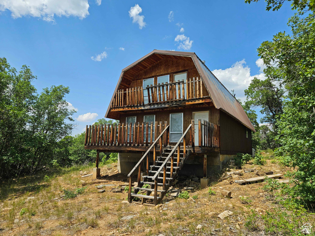 Rear view of house featuring a balcony