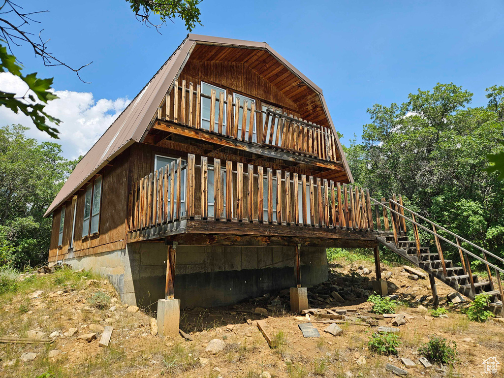 View of property exterior with a wooden deck