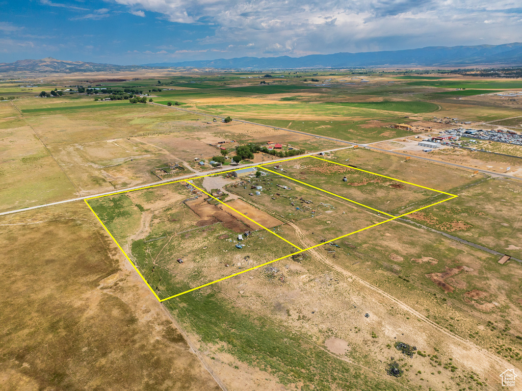Birds eye view of property with a rural view and a mountain view
