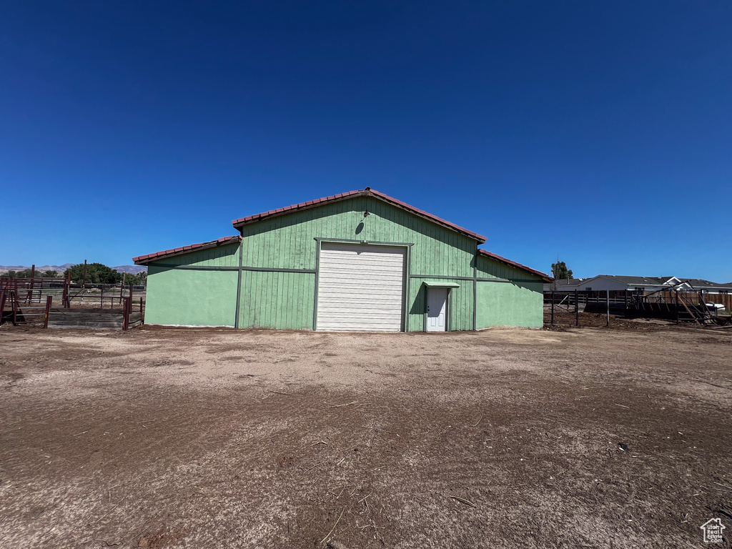 View of outbuilding featuring a garage