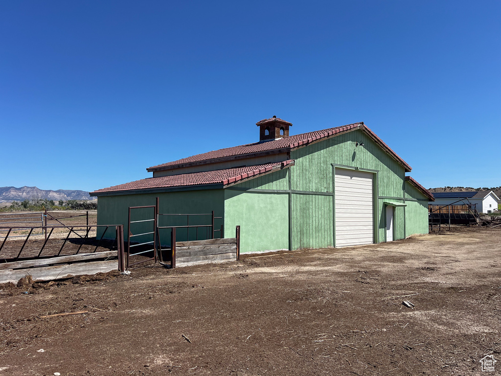 View of outdoor structure featuring a garage and a mountain view