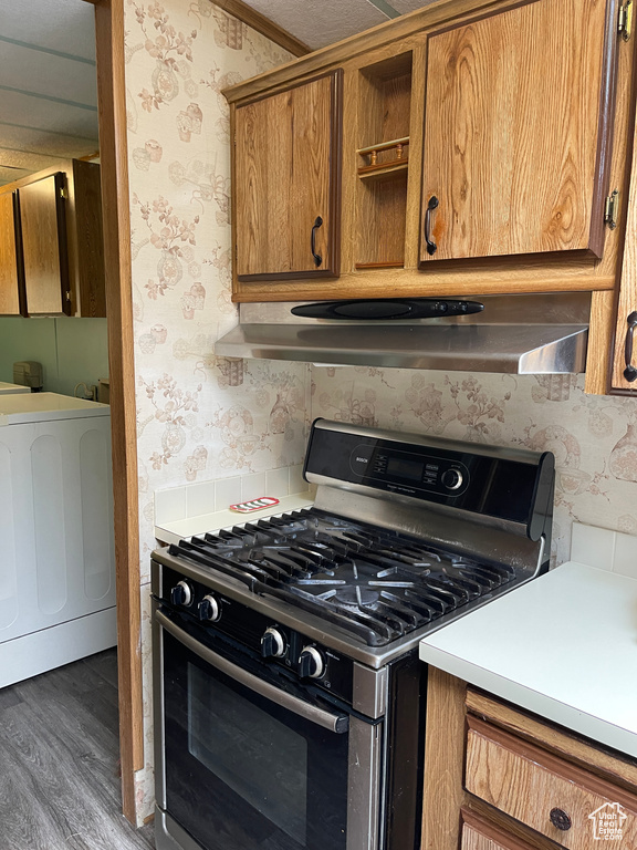 Kitchen featuring range with gas stovetop, dark hardwood / wood-style floors, and exhaust hood