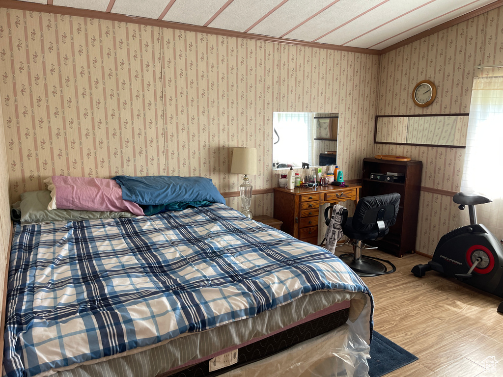 Bedroom with wood-type flooring