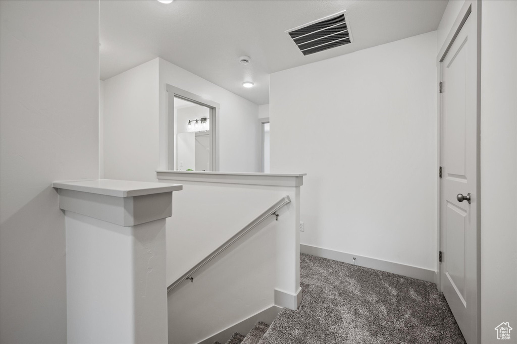 Hallway with dark carpet