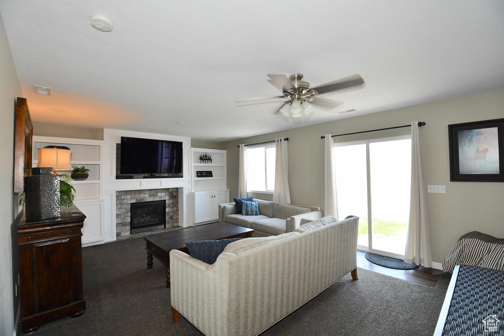 Carpeted living room featuring ceiling fan