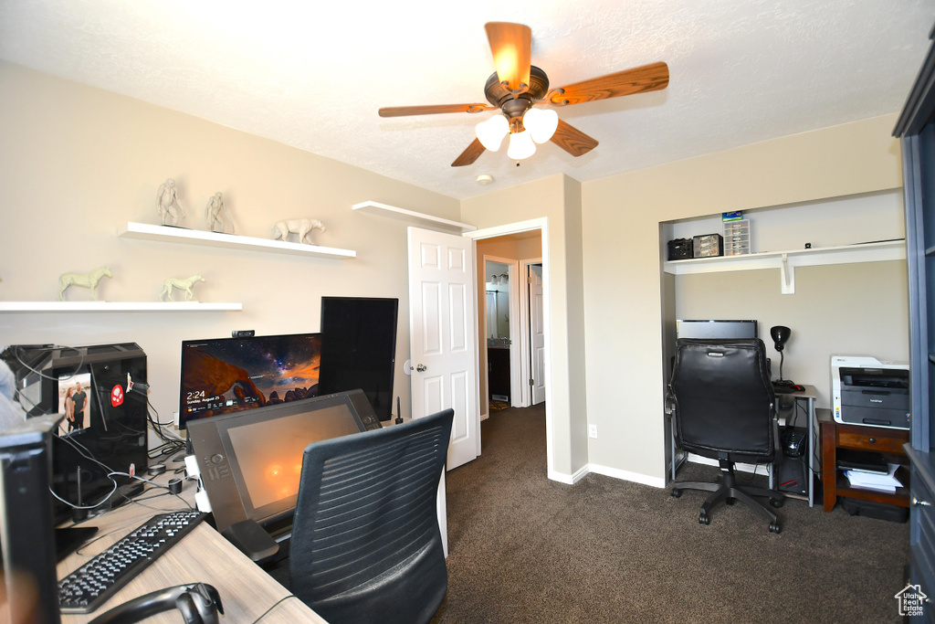 Carpeted office space featuring ceiling fan