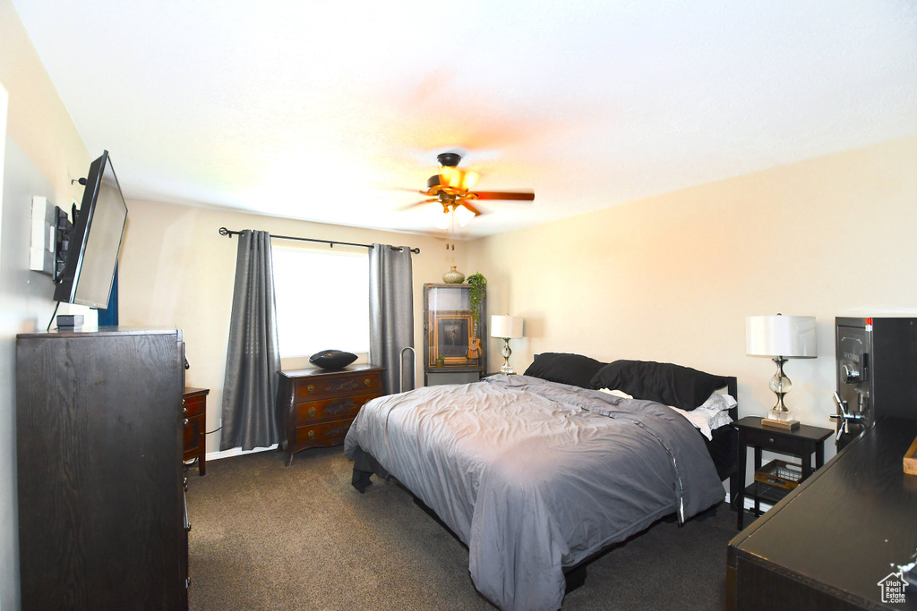 Carpeted bedroom with ceiling fan