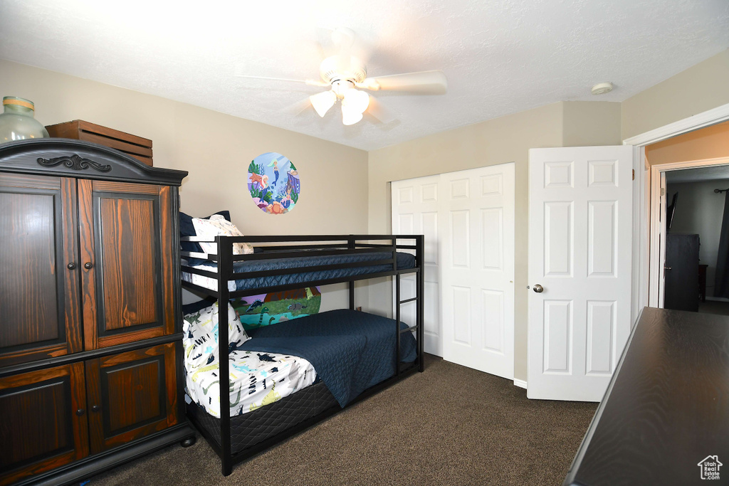 Carpeted bedroom with ceiling fan