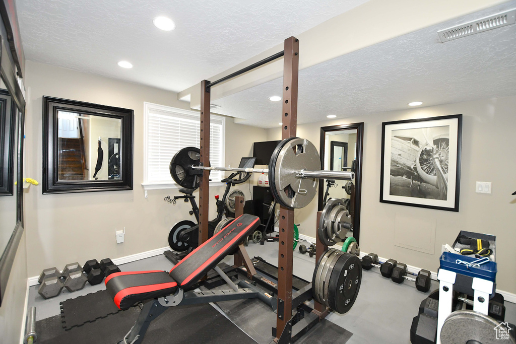 Exercise room with a textured ceiling