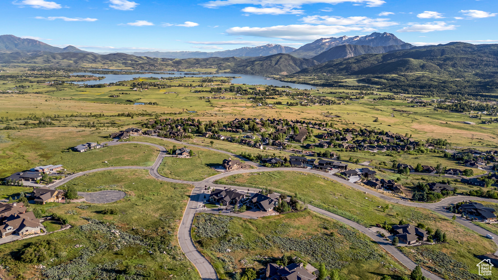 Birds eye view of property featuring a water and mountain view