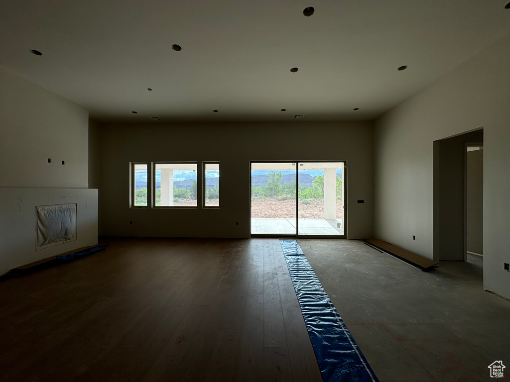 Empty room featuring a wealth of natural light and hardwood / wood-style flooring