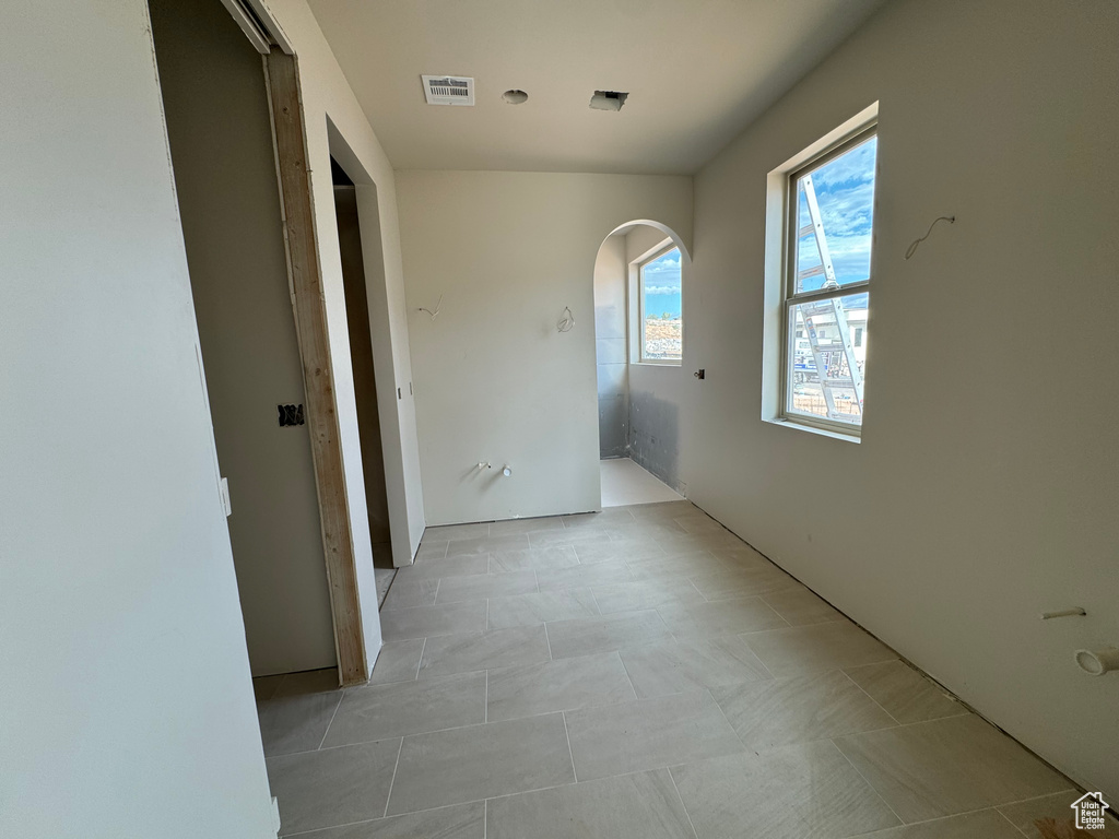 Hallway featuring light tile patterned floors