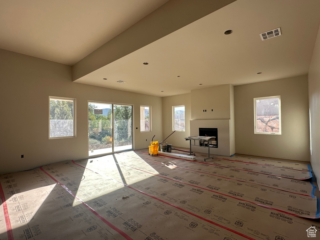 Living room featuring light colored carpet and a fireplace