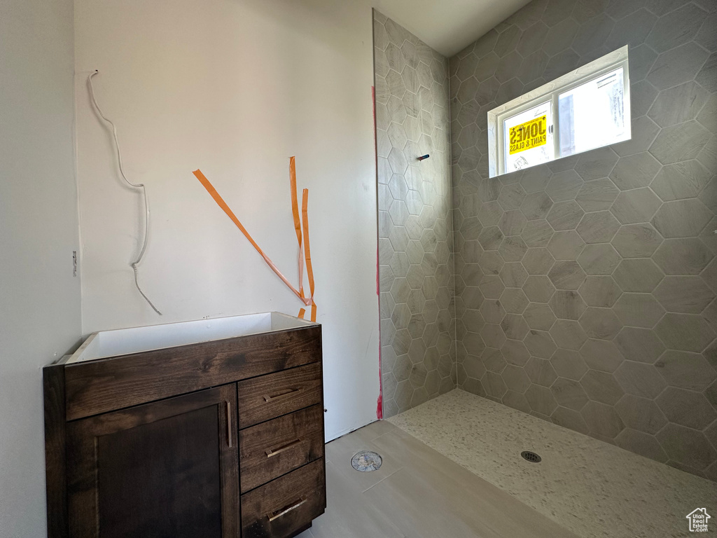 Bathroom featuring vanity and tiled shower