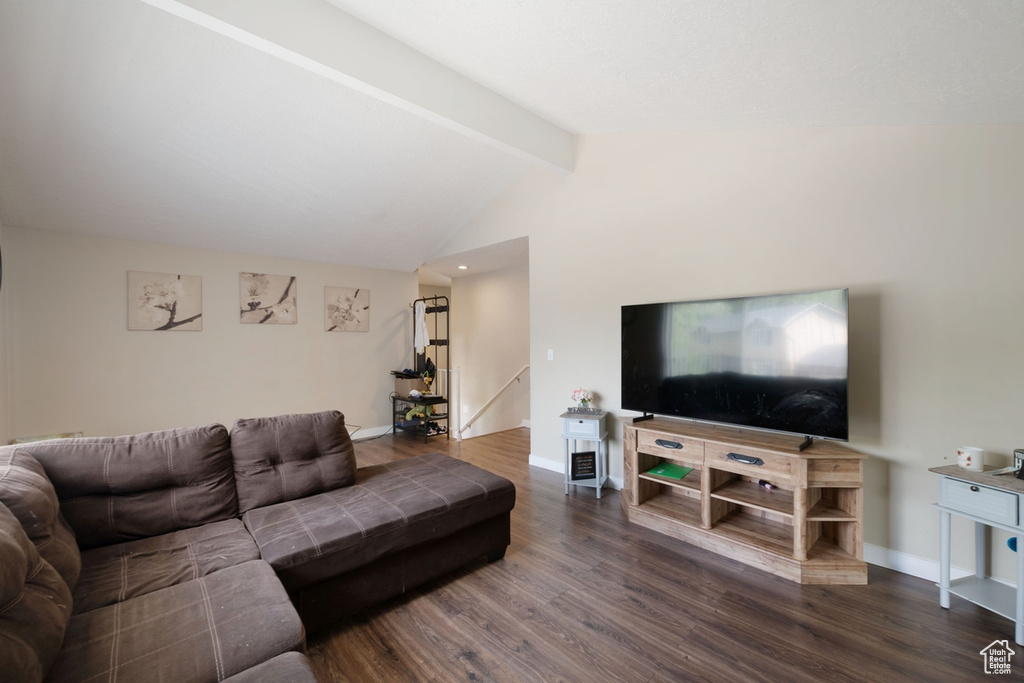 Living room with vaulted ceiling with beams and wood-type flooring